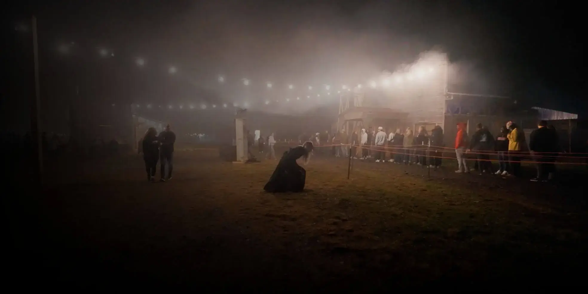 Foggy festival field at night with lights and scattered guests at Cincinnati Fear Fest