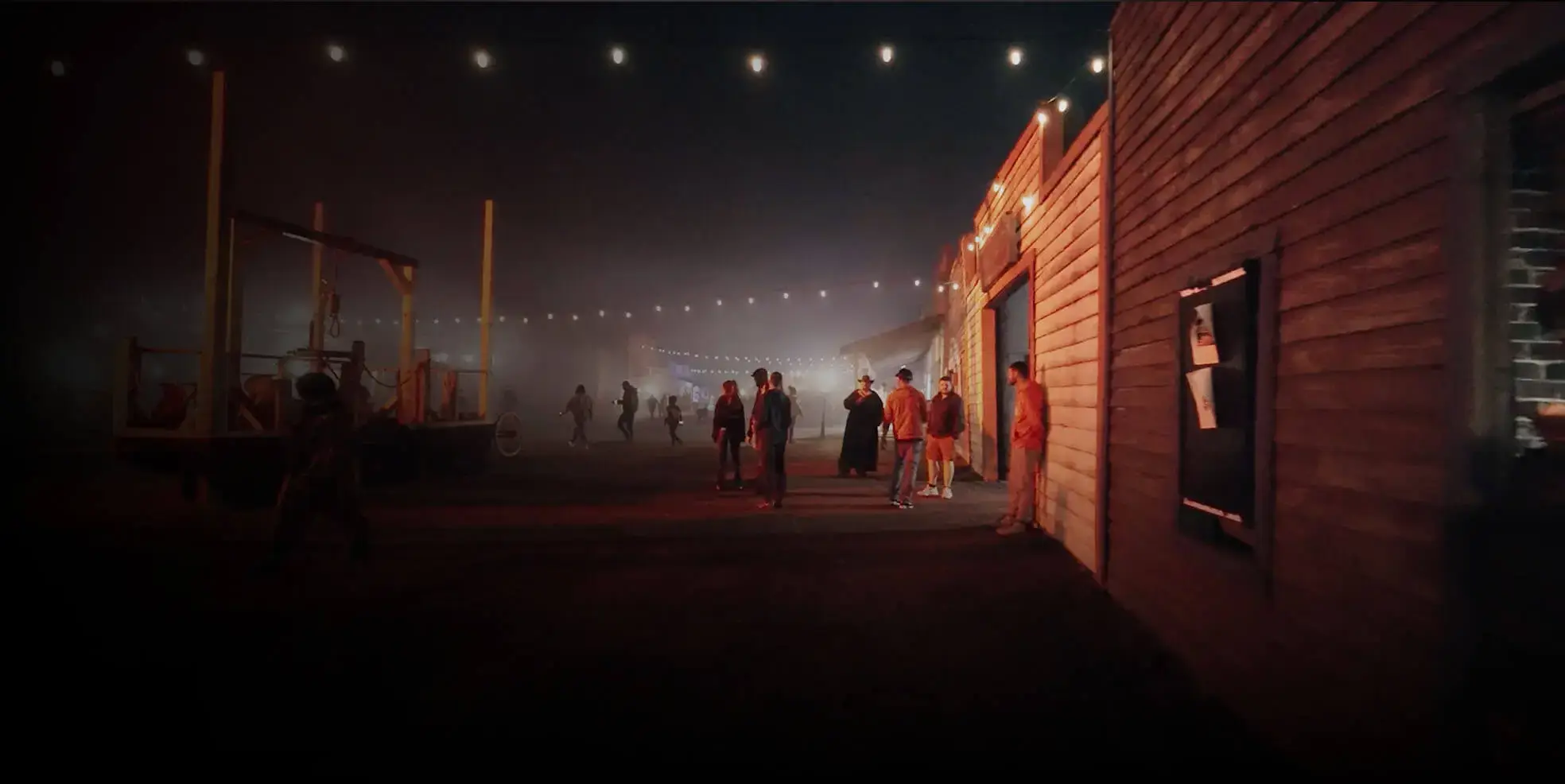 Guests walking through foggy midway at Cincinnati Fear Fest outdoor haunted house