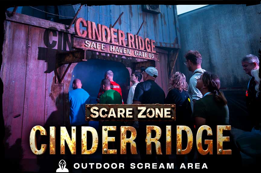 A group of terrified guests cautiously approaches a rusty, smoke-filled industrial gateway labeled "Cinder Ridge Safe Haven Gate 03." The text below reads "Scare Zone Cinder Ridge. Outdoor Scream Area."