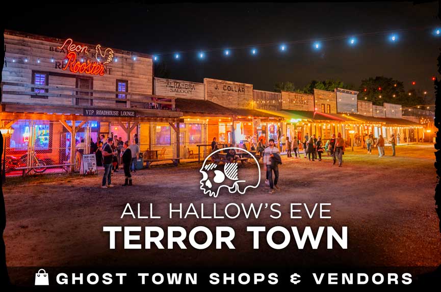 A wide night shot of an old-western style ghost town street lined with rustic wooden storefronts and illuminated by warm string lights, with patrons walking through the area. The text reads "All Hallow's Eve Terror Town. Ghost Town Shops & Vendors."